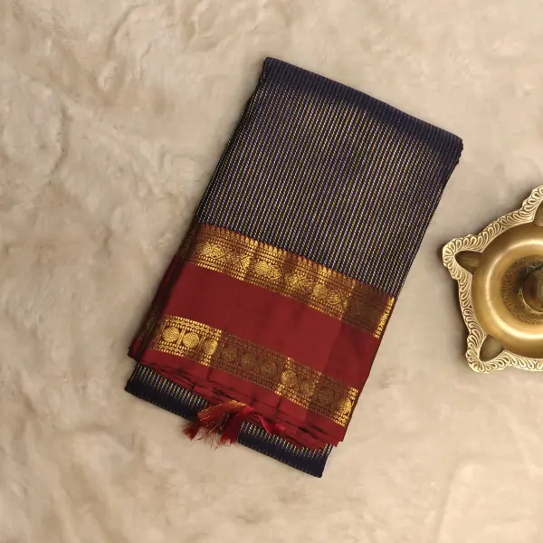 Navy blue with gold and silver verticle lines red border pure silk saree