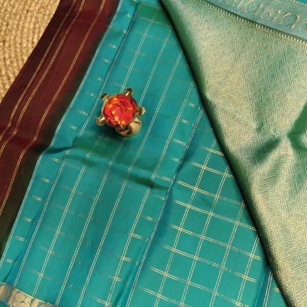 Brown checks with blue contrast peacock border silk saree